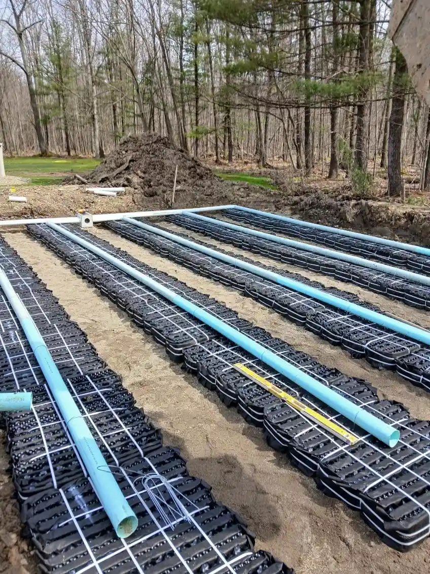 Septic leach field laterals and distribution piping installed in a stone bed on a Chautauqua County property